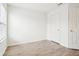 Bright bedroom with light hardwood floors, white walls, and two white doors at 8074 Carina Dr, Indianapolis, IN 46268