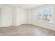 Bright bedroom with light hardwood floors, two white doors and large sunny windows at 8074 Carina Dr, Indianapolis, IN 46268