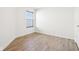 A sunlit bedroom offers new vinyl floors and a large window at 8074 Carina Dr, Indianapolis, IN 46268