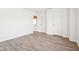 Spacious bedroom with light hardwood floors and a doorway to another room at 8074 Carina Dr, Indianapolis, IN 46268