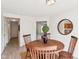 Dining room with wood table, seating for four, and view to living room at 8074 Carina Dr, Indianapolis, IN 46268