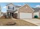Charming two-story home with brick accents, a two-car garage, and a cozy front yard fire pit at 8074 Carina Dr, Indianapolis, IN 46268