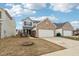 Charming two-story home with brick accents and a spacious two-car garage on a sunny day at 8074 Carina Dr, Indianapolis, IN 46268