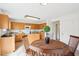 Eat-in kitchen with wood cabinets, island, stainless steel appliances, and modern lighting at 8074 Carina Dr, Indianapolis, IN 46268