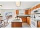 Kitchen with wood cabinets, center island, and stainless steel appliances and sliding glass door at 8074 Carina Dr, Indianapolis, IN 46268