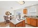 Kitchen with wood cabinets, center island, and stainless steel appliances at 8074 Carina Dr, Indianapolis, IN 46268