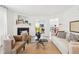 Bright living room featuring a fireplace, seating, and view into dining room at 8074 Carina Dr, Indianapolis, IN 46268