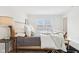 Bright bedroom featuring a bed, hardwood floors, and a light-filled window at 8074 Carina Dr, Indianapolis, IN 46268