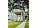 Inviting two-story home featuring neutral siding and a covered front porch entryway at 857 N Oakland Ave, Indianapolis, IN 46201