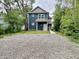 Charming two-story blue home with modern architectural style and well-maintained gravel front yard at 857 N Oakland Ave, Indianapolis, IN 46201