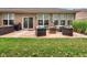 Backyard patio featuring wicker furniture with colorful cushions and an outdoor gas fire pit at 8727 Faulkner Dr, Indianapolis, IN 46239