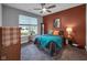 Comfortable bedroom featuring a ceiling fan, gray carpet, and decorative accents at 8727 Faulkner Dr, Indianapolis, IN 46239