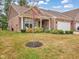 Charming home featuring a two-car garage, brick exterior, and well-maintained landscaping at 8727 Faulkner Dr, Indianapolis, IN 46239