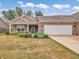 Charming brick ranch home featuring a manicured lawn, flower beds and an attached two car garage at 8727 Faulkner Dr, Indianapolis, IN 46239