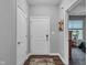 Bright hallway with white doors and a rug leading into the home at 8727 Faulkner Dr, Indianapolis, IN 46239