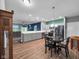 Open kitchen featuring gray cabinets, stainless steel appliances, island and modern pendant lighting at 8727 Faulkner Dr, Indianapolis, IN 46239