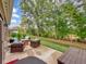 Outdoor patio with comfortable wicker furniture, green yard, and natural views at 8727 Faulkner Dr, Indianapolis, IN 46239