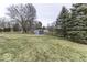 Expansive backyard featuring a shed, mature trees, and a secure black fence, perfect for outdoor activities and relaxation at 8901 Rocky Ridge Rd, Indianapolis, IN 46217