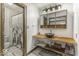 Modern bathroom with a unique sink, wood-look shelf, decorative shower curtain and hexagonal tile floor at 8901 Rocky Ridge Rd, Indianapolis, IN 46217