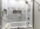 Elegant bathroom featuring a bathtub with glass doors and decorative tile surround at 8901 Rocky Ridge Rd, Indianapolis, IN 46217