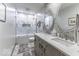 Updated bathroom featuring a marble countertop with dual sinks and a shower/tub combo at 8901 Rocky Ridge Rd, Indianapolis, IN 46217