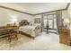 Bright bedroom featuring a wooden bed frame, desk, and large windows at 8901 Rocky Ridge Rd, Indianapolis, IN 46217