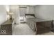 Bedroom with a twin bed, white walls, and a dresser, illuminated by natural light from the window at 8901 Rocky Ridge Rd, Indianapolis, IN 46217