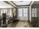 Bright foyer featuring a decorative front door, wooden trim, and a glimpse into the living room at 8901 Rocky Ridge Rd, Indianapolis, IN 46217