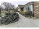 This home features a well-lit sidewalk, brick facade, manicured shrubs, and an attached garage at 8901 Rocky Ridge Rd, Indianapolis, IN 46217