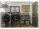 Laundry room featuring a washing machine, dryer, utility sink, and storage cabinet at 8901 Rocky Ridge Rd, Indianapolis, IN 46217