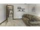 Comfortable living room featuring a patterned couch and a view into the bedroom at 8901 Rocky Ridge Rd, Indianapolis, IN 46217