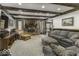 Cozy living room with a brick fireplace, comfortable seating, and natural light at 8901 Rocky Ridge Rd, Indianapolis, IN 46217
