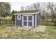 Outdoor backyard shed for extra storage featuring double doors and a charming, functional design at 8901 Rocky Ridge Rd, Indianapolis, IN 46217