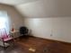 Unfinished attic space with wood floors, neutral walls, and a window for natural light at 1023 Union St, Columbus, IN 47201