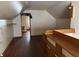 Attic space with hardwood floors, slanted ceilings, and built-in shelving at 1023 Union St, Columbus, IN 47201