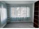 Bedroom with a built in bookshelf, soft curtains, and new gray carpeting at 1023 Union St, Columbus, IN 47201