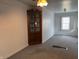 Corner bedroom with a vintage cabinet, neutral walls, and new gray carpeting at 1023 Union St, Columbus, IN 47201