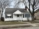 Charming bungalow-style home with white siding, classic black shutters, and well-maintained front yard at 1023 Union St, Columbus, IN 47201