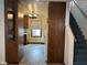 Hallway with a partial view of the kitchen with wood cabinets and access to a staircase at 1023 Union St, Columbus, IN 47201