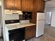 Well-equipped kitchen with matching appliances, wooden cabinets, and linoleum flooring at 1023 Union St, Columbus, IN 47201