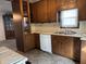 Traditional kitchen featuring wood cabinetry, laminate countertops, and modern appliances at 1023 Union St, Columbus, IN 47201
