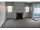 Living room featuring new gray carpeting, fireplace, built-in shelving, and neutral paint at 1023 Union St, Columbus, IN 47201