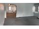 Spacious living room featuring new gray carpeting and a large arched doorway to other rooms at 1023 Union St, Columbus, IN 47201