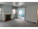 Comfortable living room featuring new gray carpeting, fireplace, and built-in shelving at 1023 Union St, Columbus, IN 47201