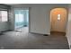 Open-concept living area with new gray carpeting and an arched doorway and multiple entryways at 1023 Union St, Columbus, IN 47201