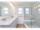 Well-lit bathroom with a double vanity, quartz countertops, modern lighting and a glass-enclosed shower at 10959 Morab Dr, Zionsville, IN 46077