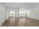 Open concept living room with wood-look floors, recessed lighting, and large windows offering ample natural light at 10959 Morab Dr, Zionsville, IN 46077