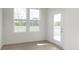 Bright sun room with wood floors, large windows overlooking a pond, and a glass door to outdoor patio at 10959 Morab Dr, Zionsville, IN 46077