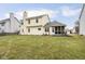 Exterior view of the home showcasing the backyard, screened-in porch, and ample green space at 11866 Weathered Edge Dr, Fishers, IN 46037