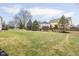 Large backyard with lush green grass, mature trees, and a wooden fence at 11866 Weathered Edge Dr, Fishers, IN 46037